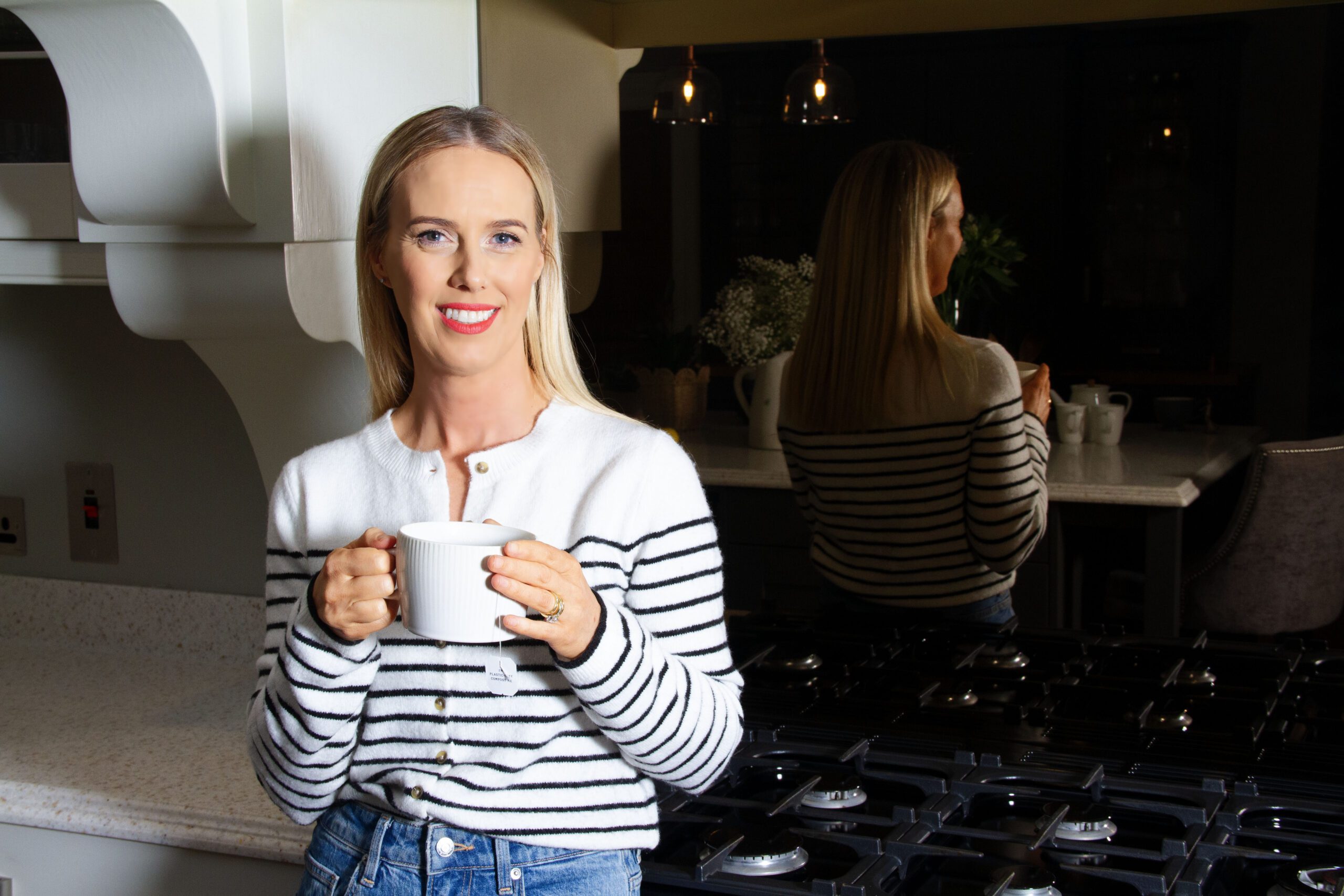 image of woman smiling sitting at a desk