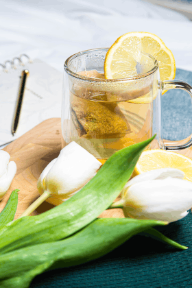 photo of laptop on desk with notebook and pen on top of it